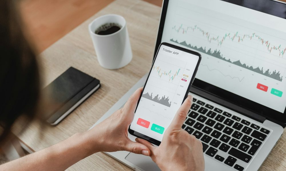 Forex trader using crypto exchange mobile phone app for investment and stock market analysis